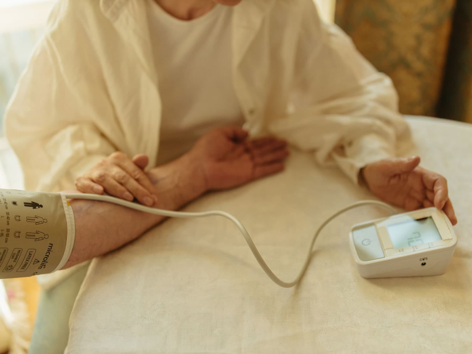 Older adult checking blood pressure at home