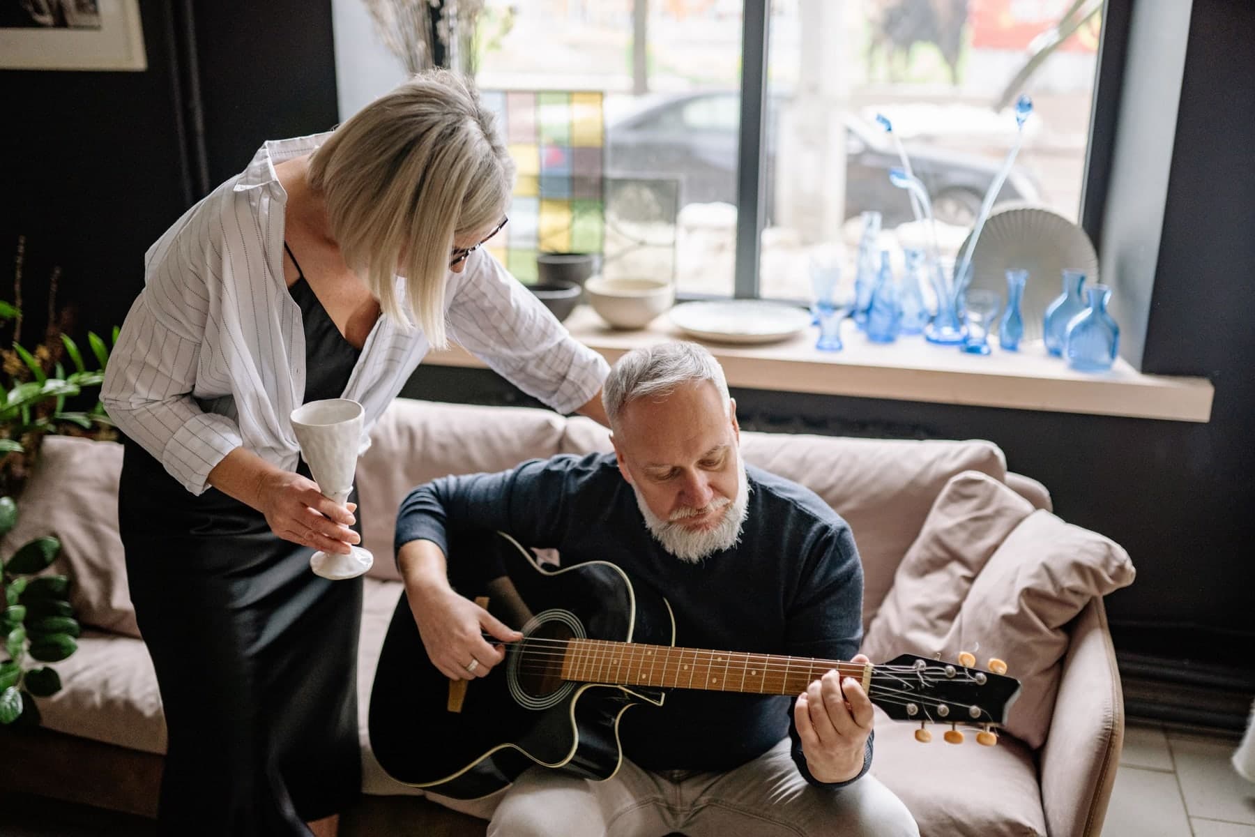 Older man practicing an acoustic guitar