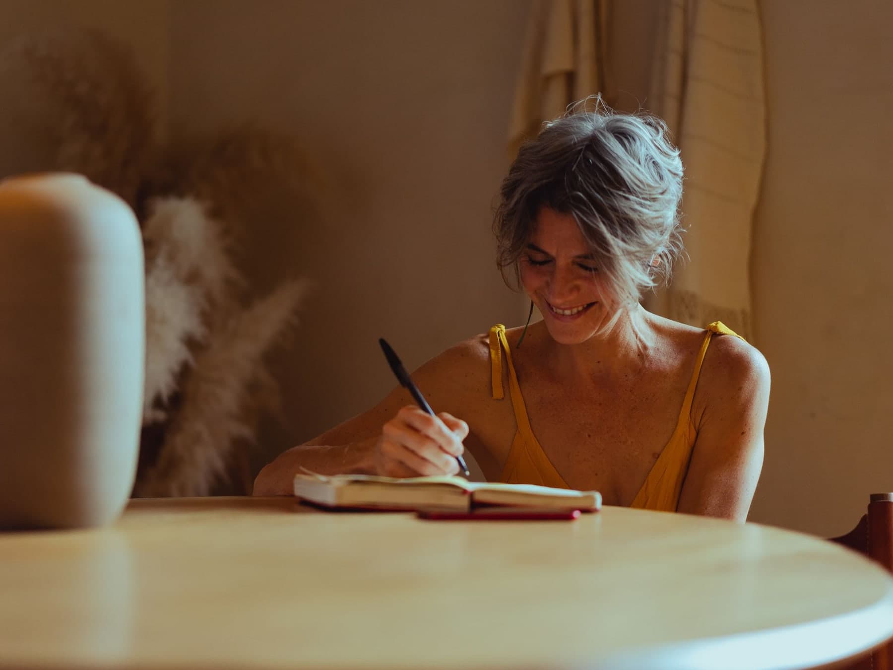 Older adult writing reminders in a notebook