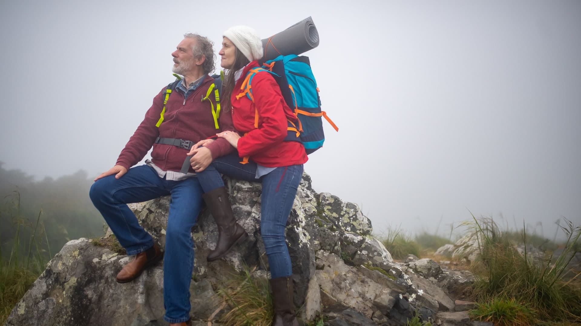 Active adults in their 60s hiking along a scenic coastal trail