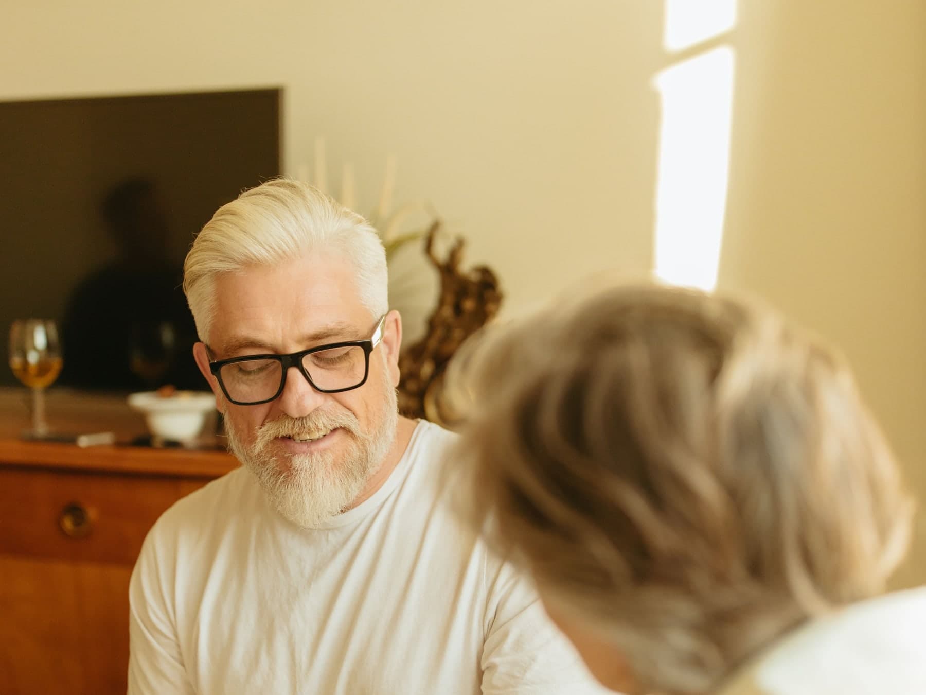 Older adult checking blood pressure with a home monitor
