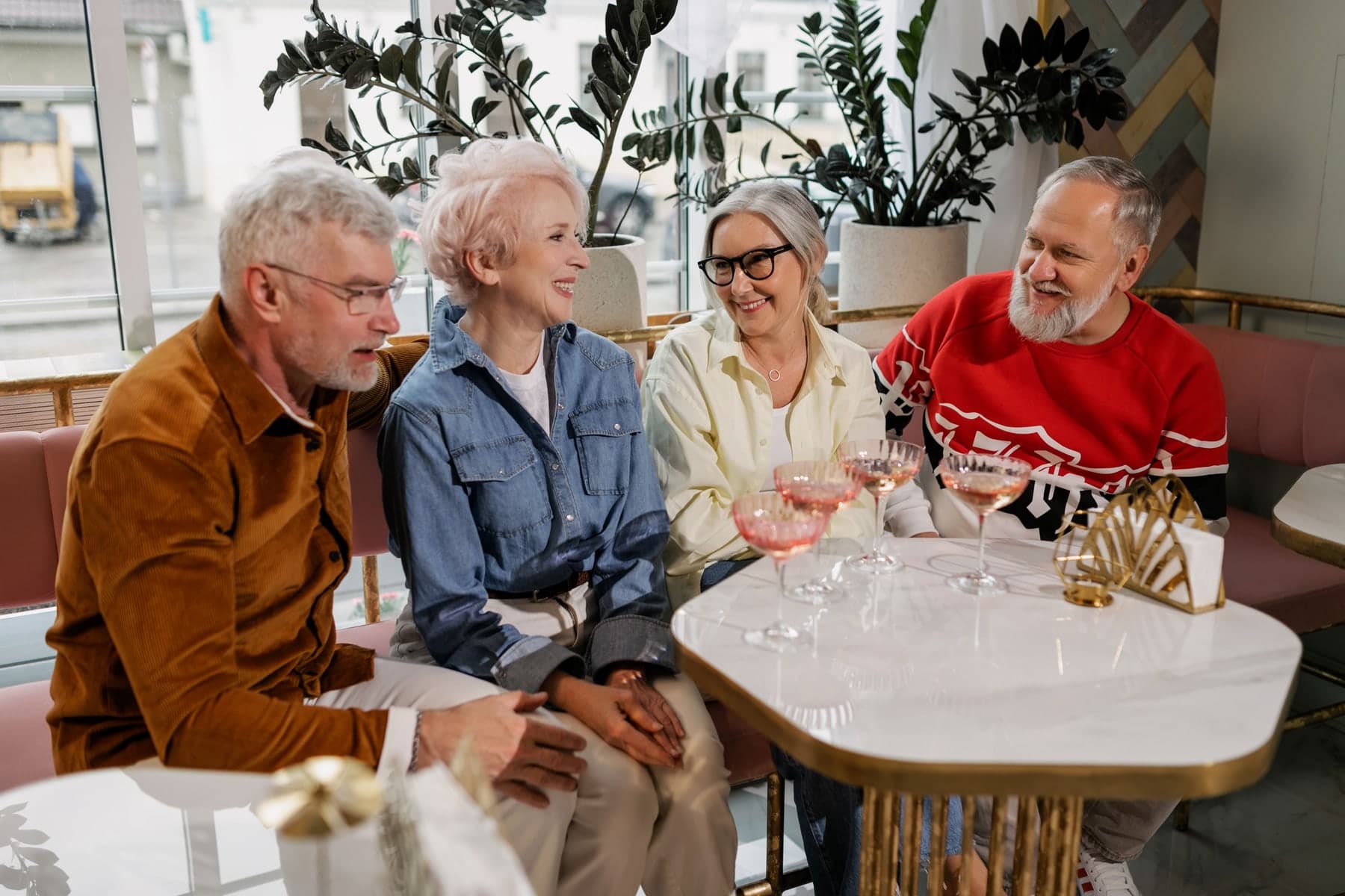 Group of mature friends sharing a meal outdoors