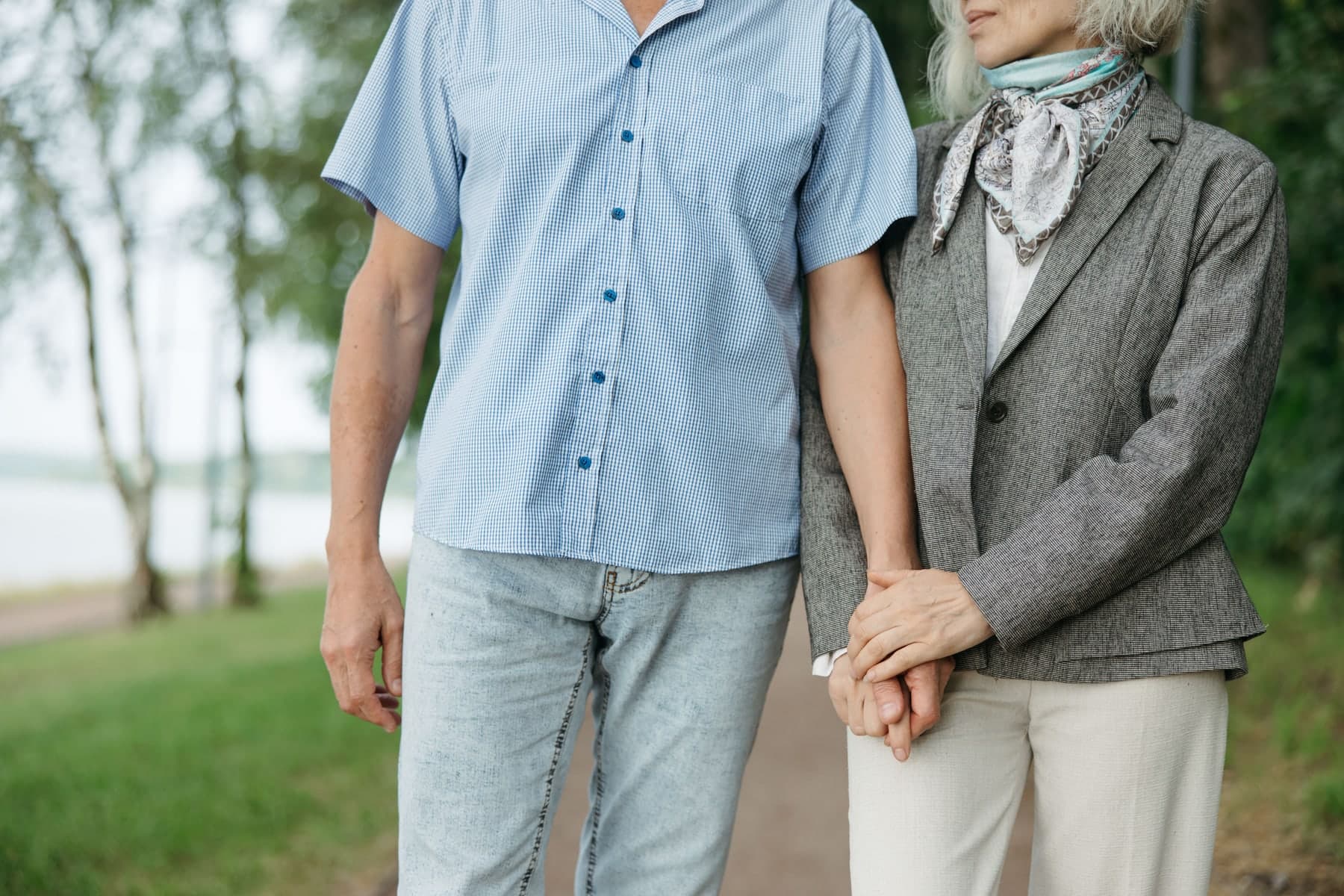 Mature couple enjoying a brisk walk along a wooded path