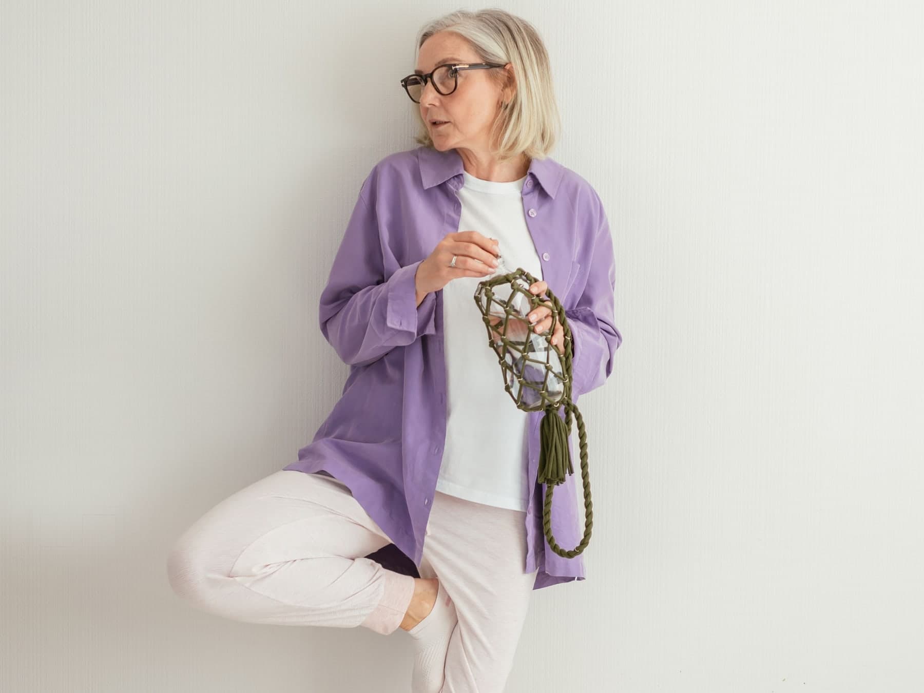 Older woman practicing a supported balance exercise at home