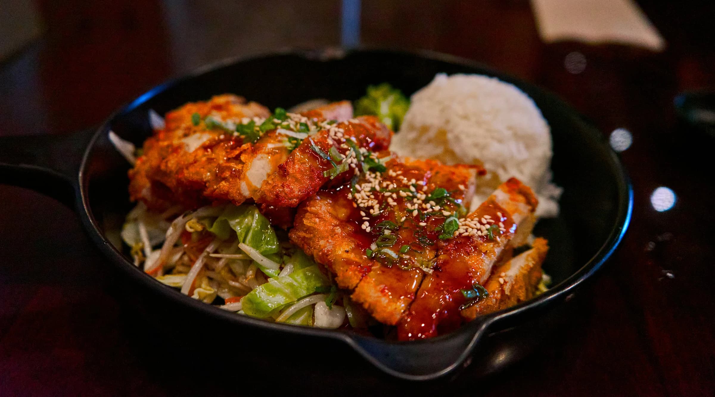 Breaded chicken served with rice and vegetables.